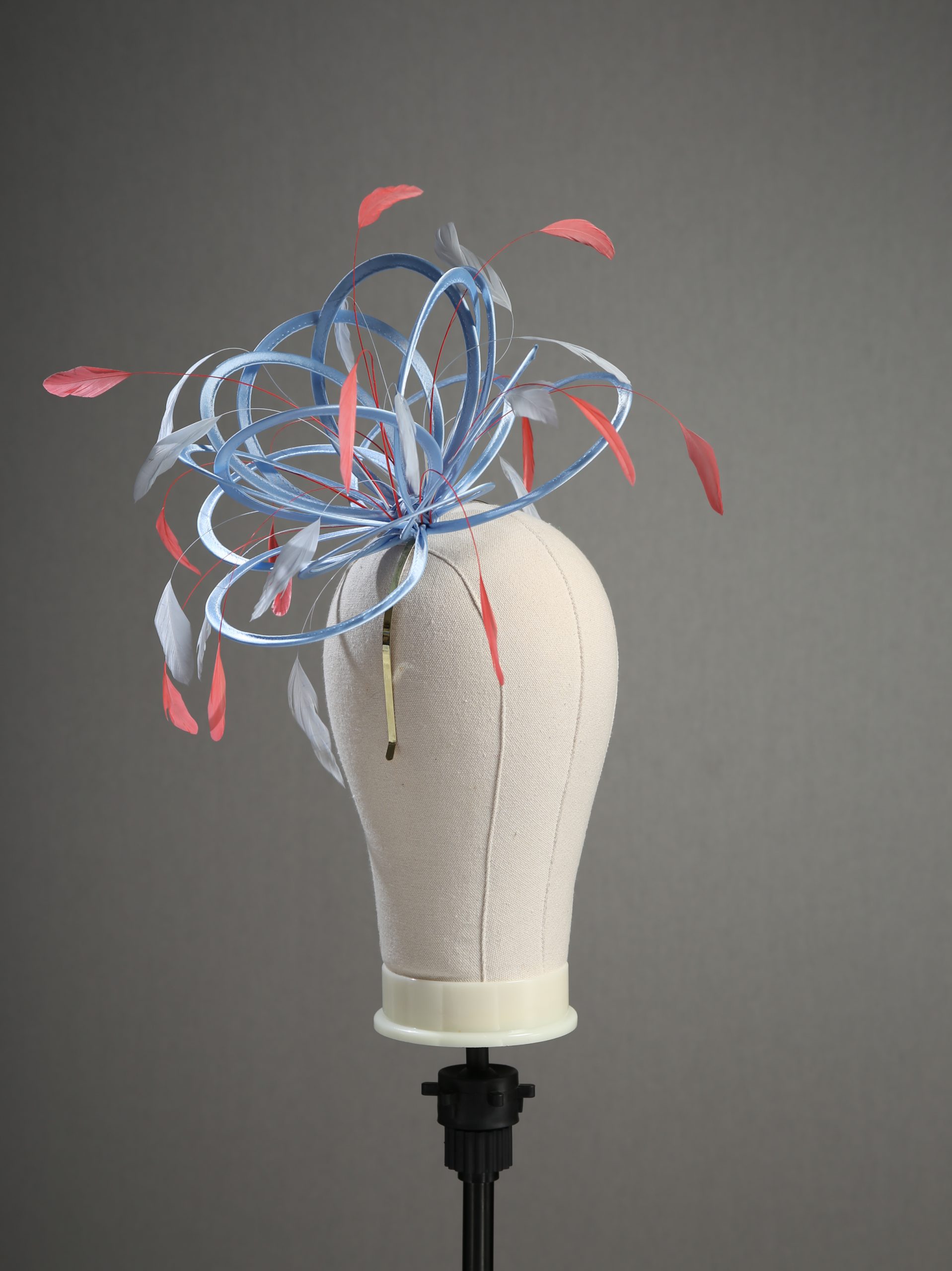 cornflower blue and coral pink medium no hackle fascinator hat (8) Ladies' formal Cornflower Blue and Coral Pink medium feather and satin loop fascinator hat. Suitable for a wedding or ladies' day at the races