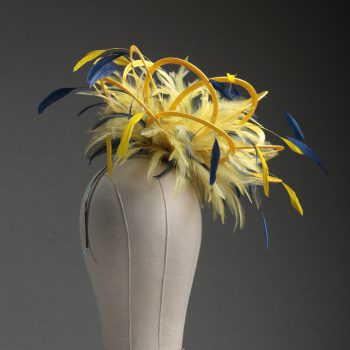 Ladies formal yellow and navy blue medium feather and satin loop fascinator hat. Suitable for a wedding or ladies day at the races