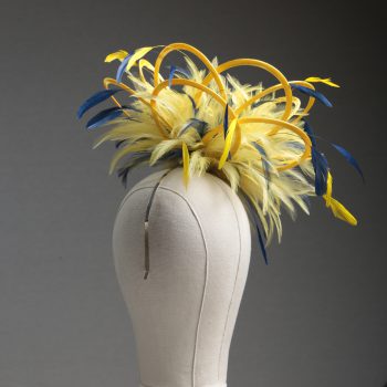 Ladies formal yellow and navy blue medium feather and satin loop fascinator hat. Suitable for a wedding or ladies day at the races