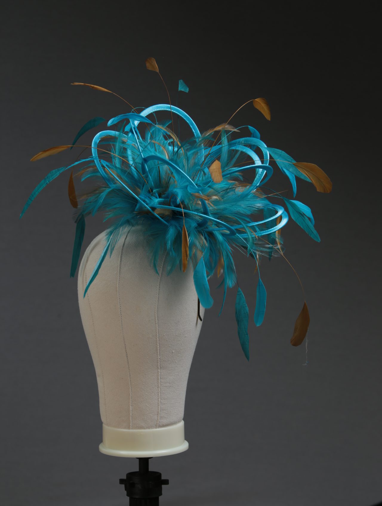Ladies' formal Turquoise and Gold medium feather and satin loop fascinator hat. Suitable for a wedding or ladies' day at the races
