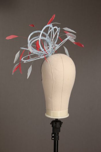 Ladies' formal Baby Blue and Coral Pink medium feather and satin loop fascinator hat. Suitable for a wedding or ladies' day at the races