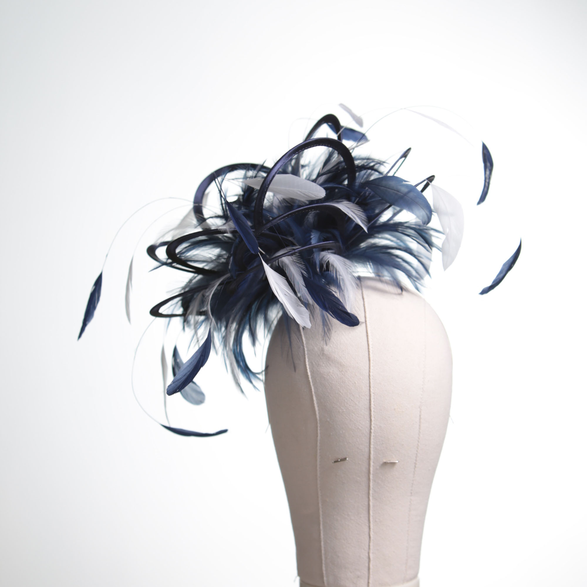 Ladies formal Navy Blue and White medium feather and satin loop fascinator hat. Suitable for a wedding or ladies day at the races