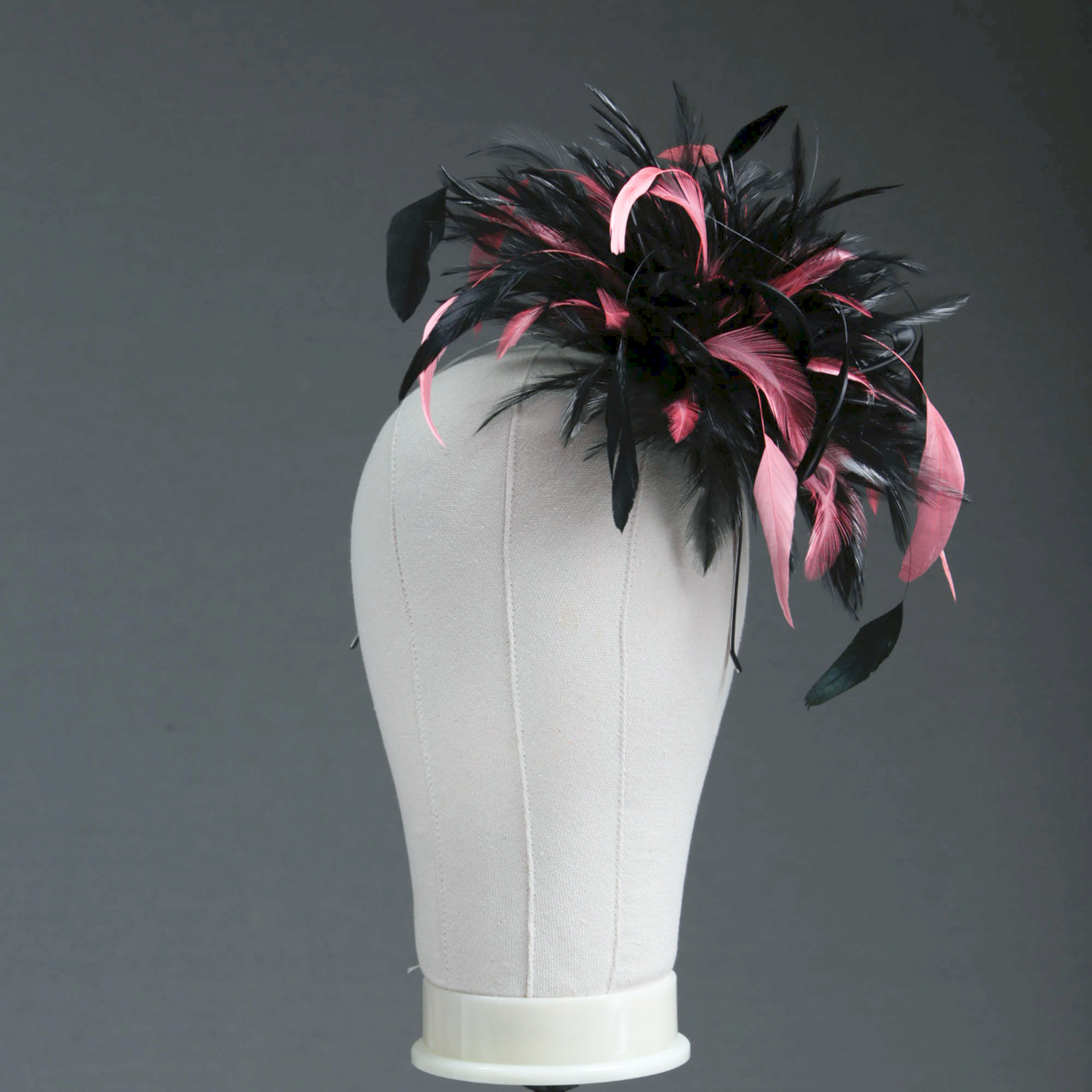 Ladies wedding or races black and coral pink small feather and satin loop fascinator hat