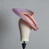 Pink lilac and oyster sinamay swirl fascinator hat set on a teardrop base