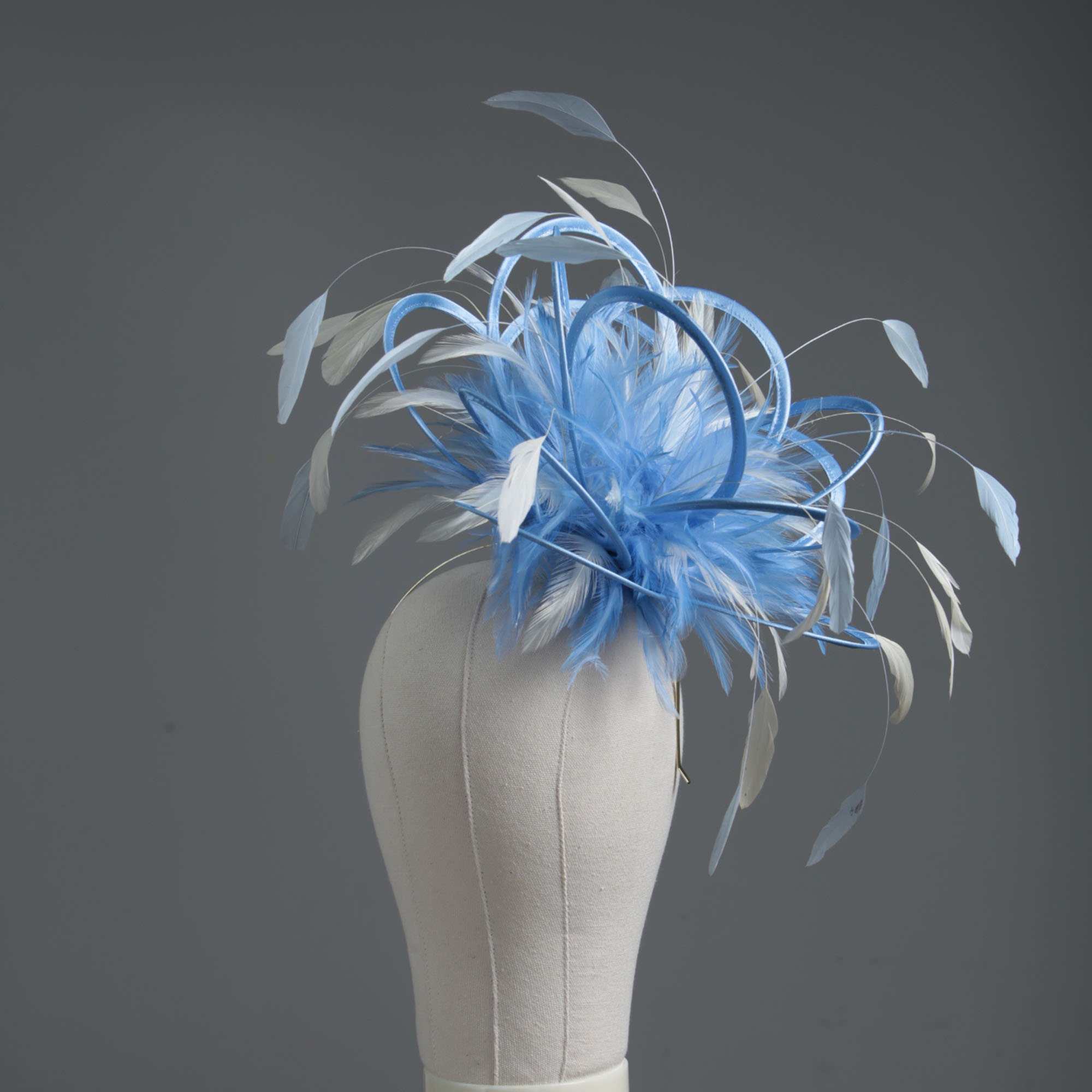 Ladies formal cornflower blue and ivory medium feather and satin loop fascinator hat. Suitable for a wedding or ladies day at the races