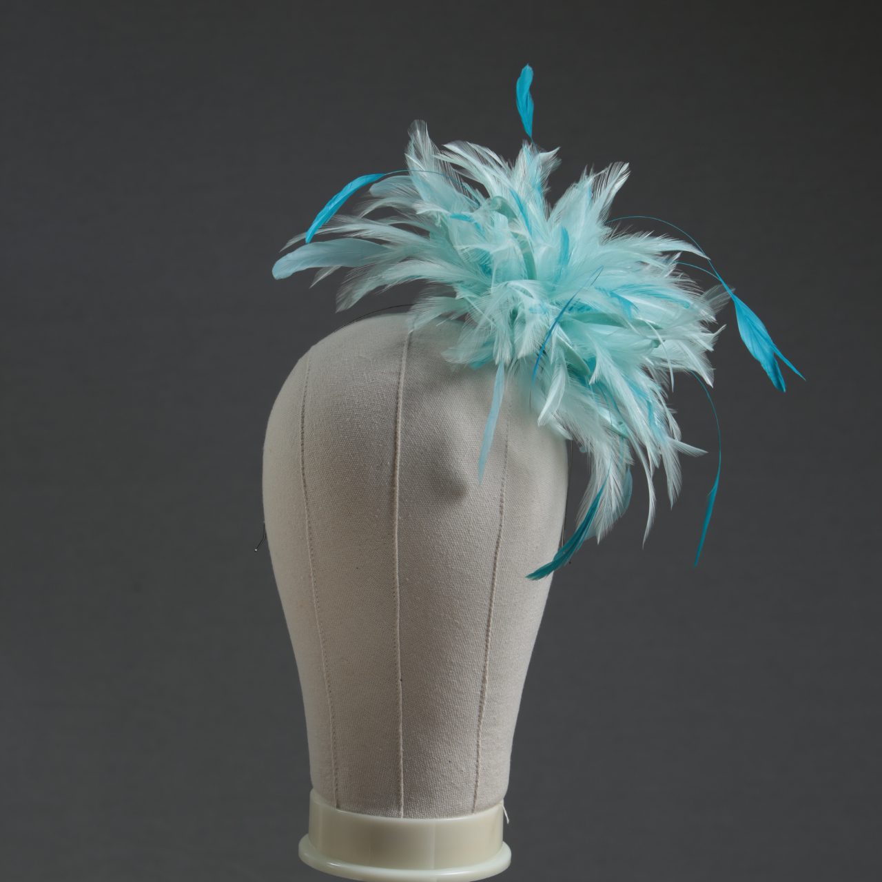 Ladies wedding or races aqua and turquoise small feather and satin loop fascinator hat
