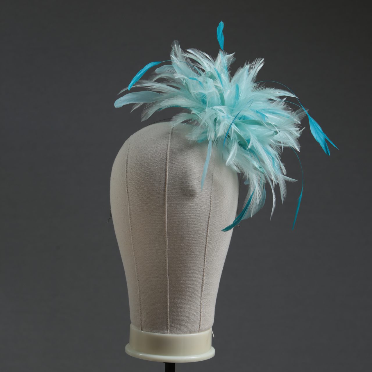 Ladies wedding or races aqua and turquoise small feather and satin loop fascinator hat