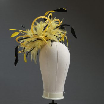 Ladies formal yellow and black medium feather and satin loop fascinator hat. Suitable for a wedding or ladies day at the races