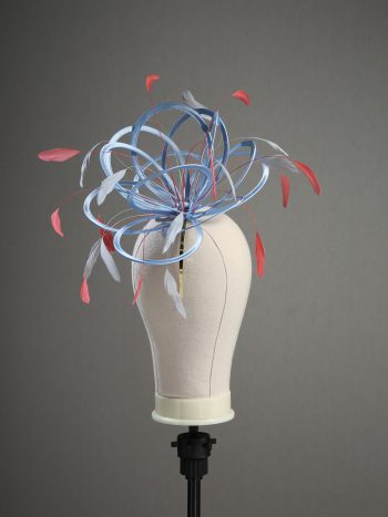 Ladies' formal Cornflower Blue and Coral Pink medium feather and satin loop fascinator hat. Suitable for a wedding or ladies' day at the races