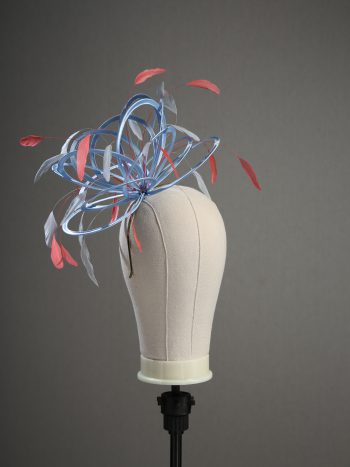 Ladies' formal Cornflower Blue and Coral Pink medium feather and satin loop fascinator hat. Suitable for a wedding or ladies' day at the races