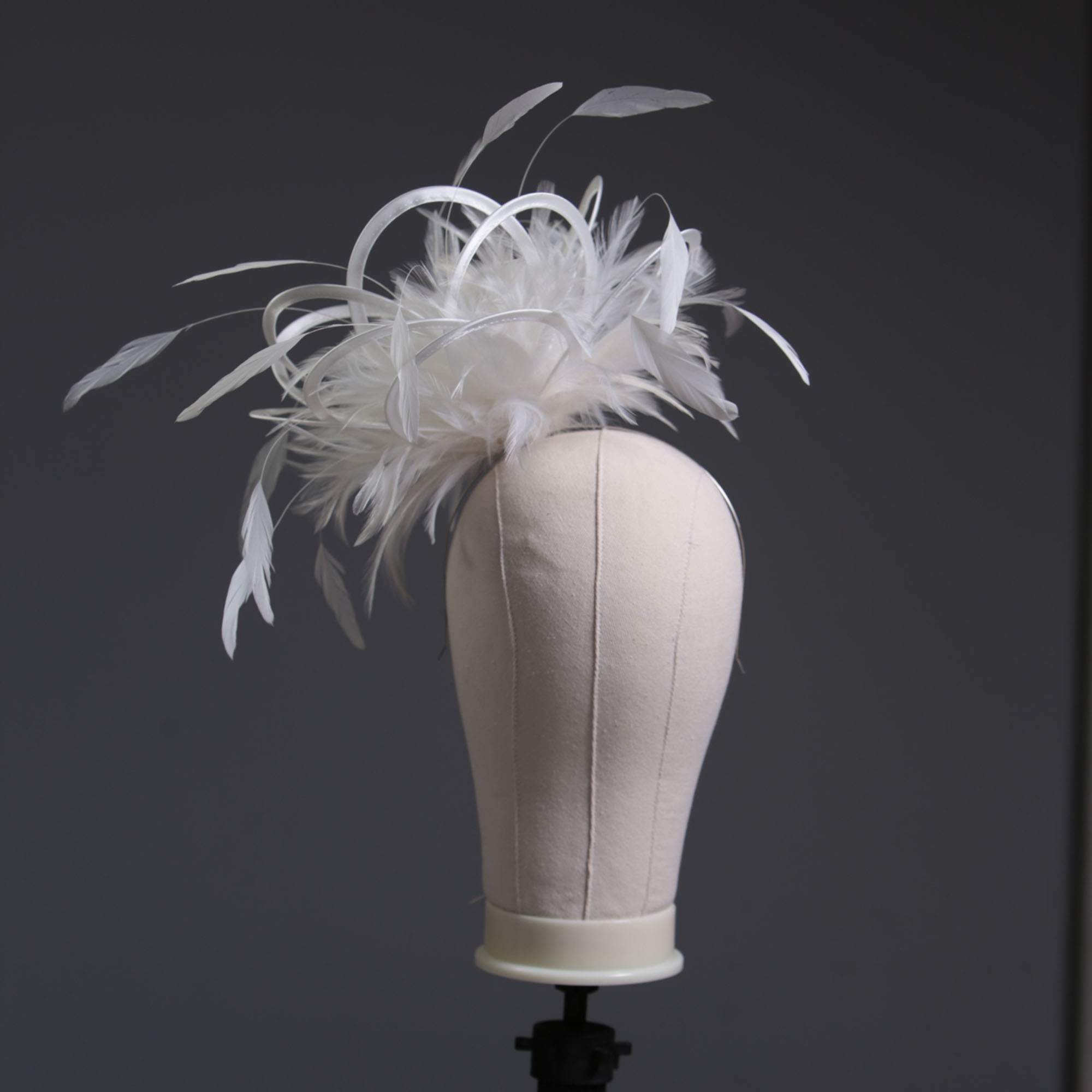 Ladies formal Ivory medium feather and satin loop fascinator hat. Suitable for a wedding or ladies day at the races