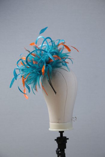 Ladies' formal Turquoise and Orange medium feather and satin loop fascinator hat. Suitable for a wedding or ladies' day at the races